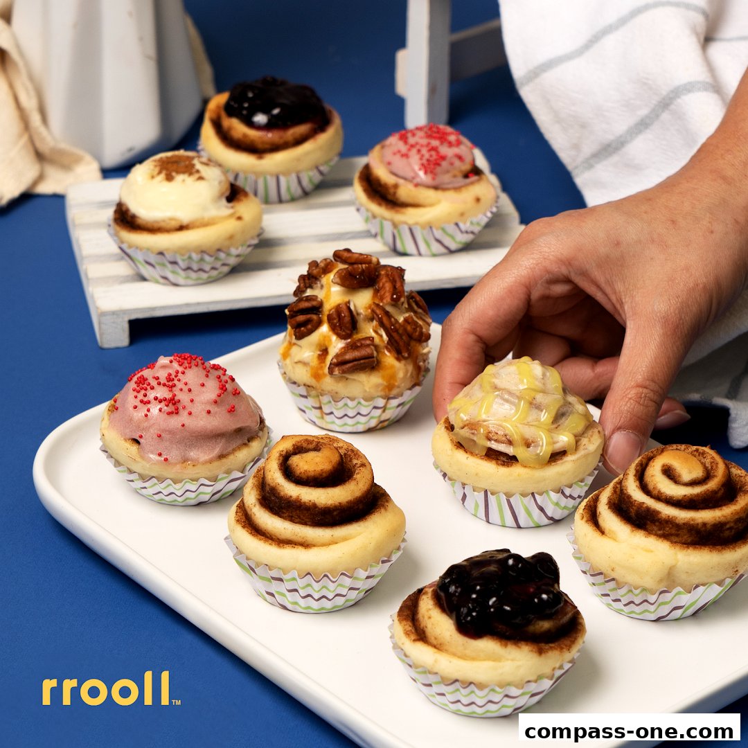 A hand reaching for a variety of delicious cinnamon rolls on a white tray.