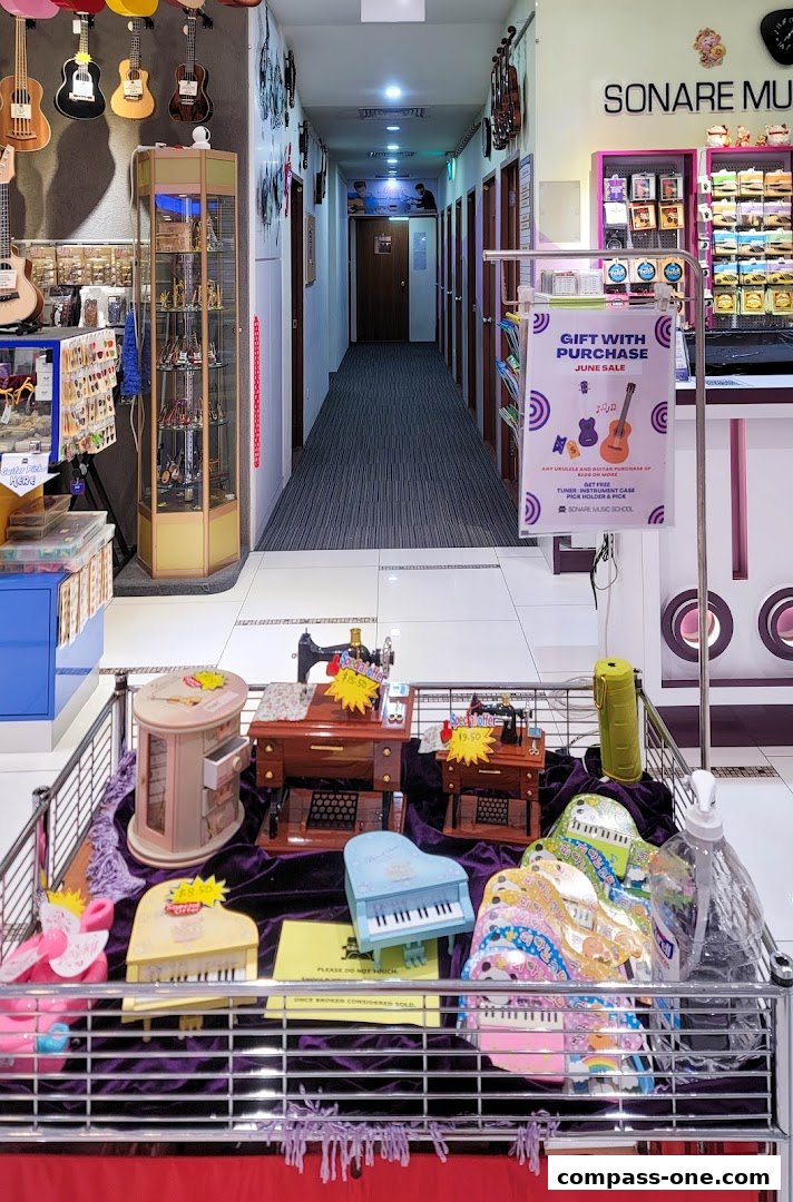 Interior view of Sonare Music School with musical instruments and displays.