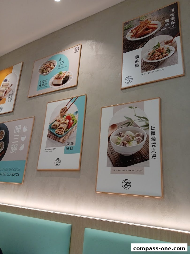 Wall display of food images at Eat 3 Bowls restaurant.