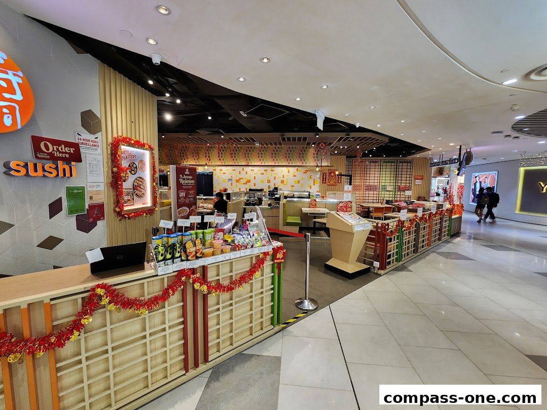 The interior of Ichiban Sushi, showcasing the counter, seating area, and sushi display.