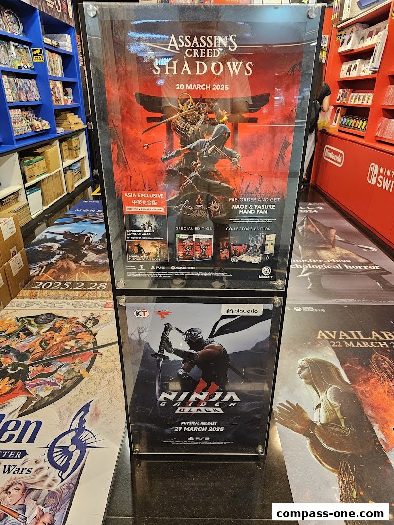 Promotional posters for Assassin's Creed Shadows and Ninja Gaiden Black displayed in a game store.