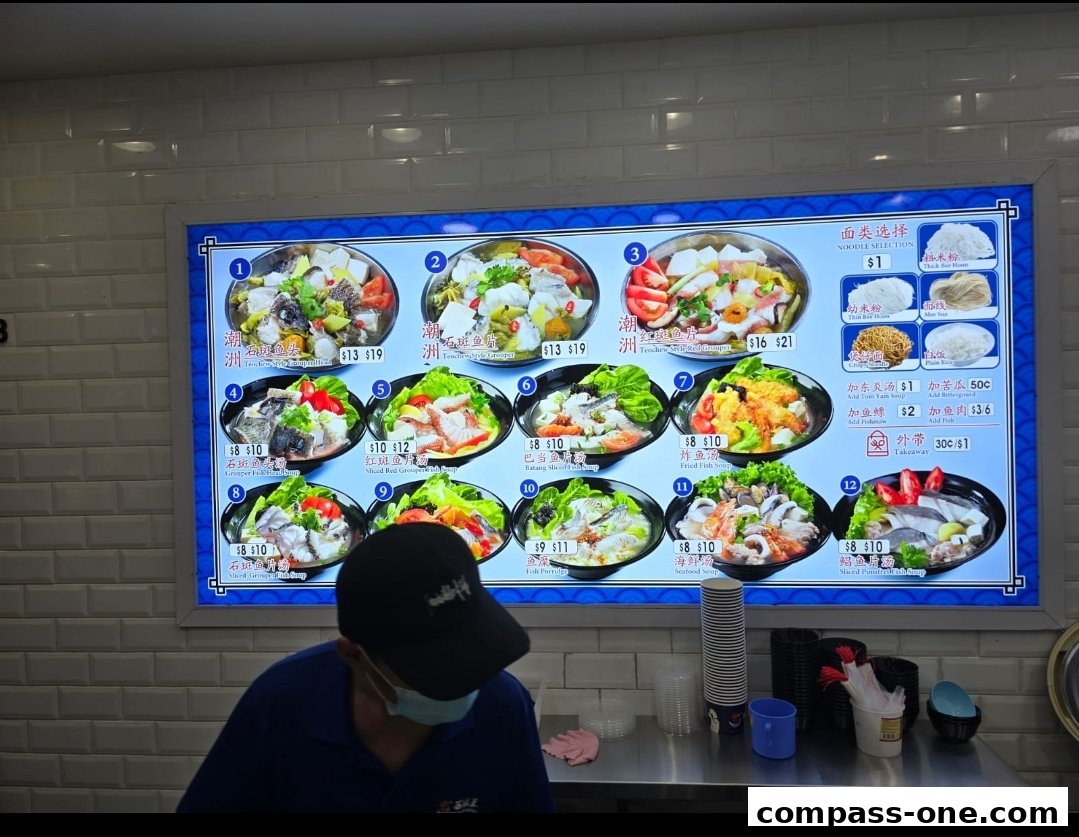 A digital menu board displays various fish soup dishes with prices and descriptions.