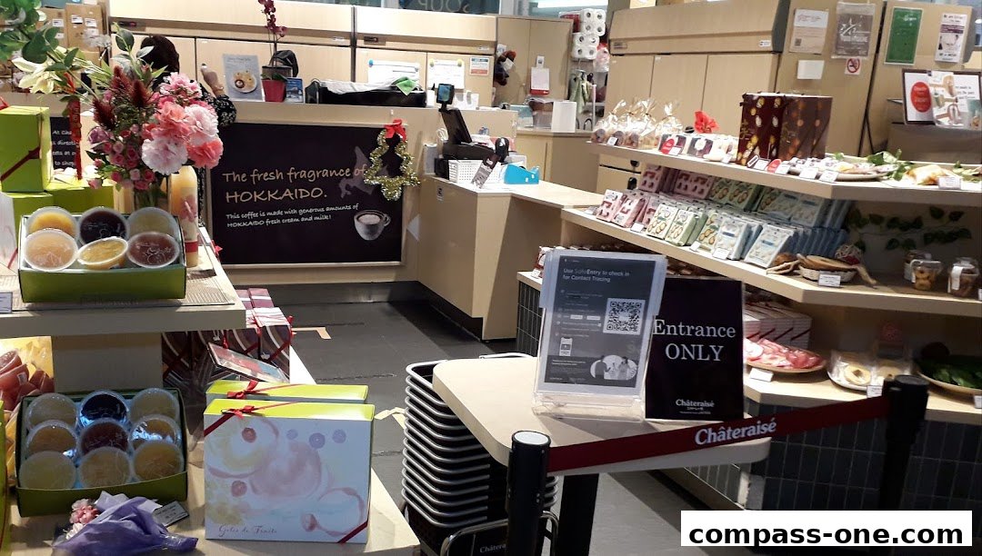Interior view of a Châteraisé shop with various pastries, gifts, and a checkout counter.
