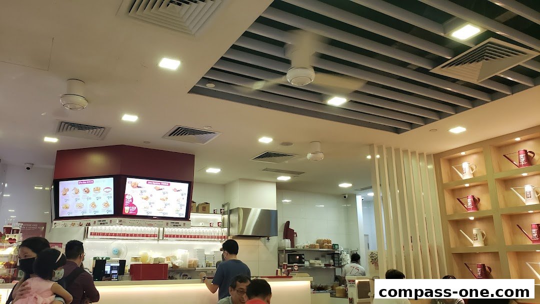 Interior of Ya Kun Kaya Toast with customers and menu displays.