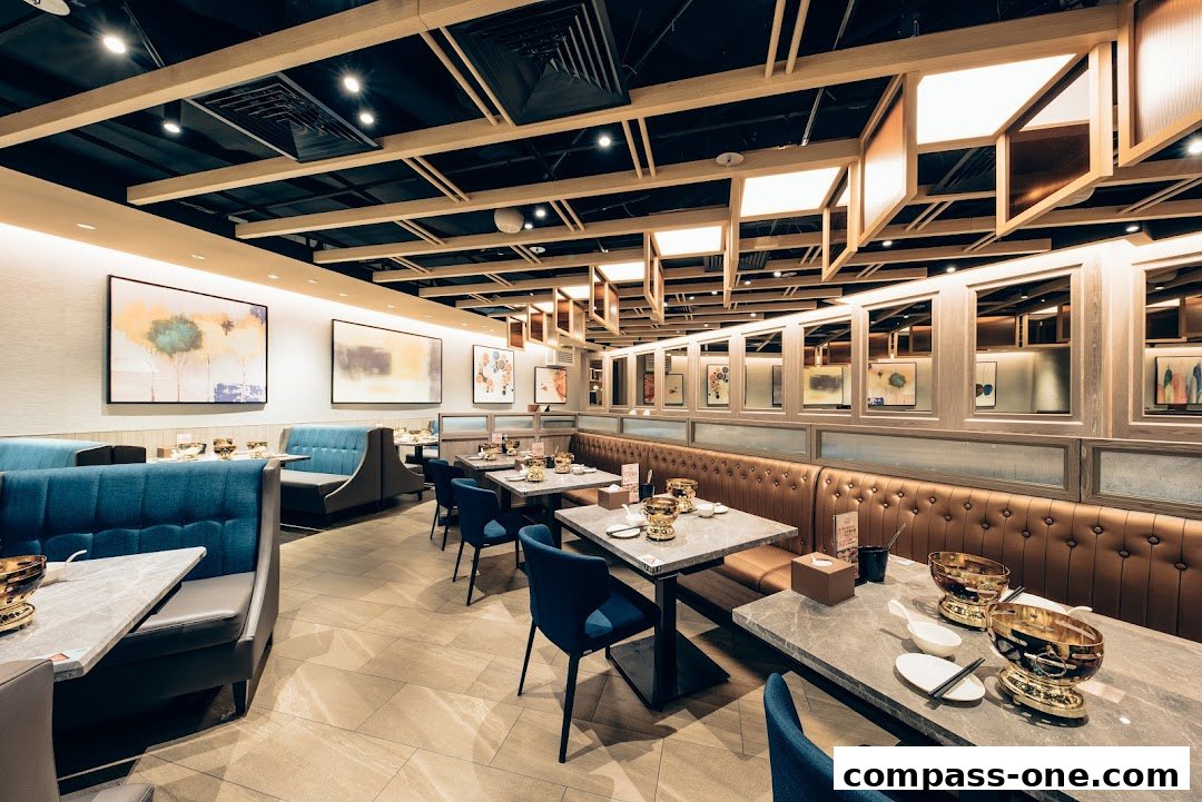 Interior view of a modern hotpot restaurant with comfortable seating and elegant decor.