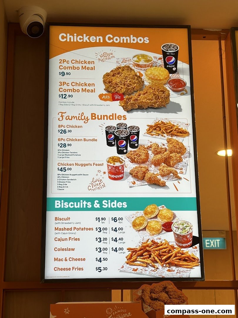 A menu board for Popeyes featuring chicken combos, family bundles, biscuits, and sides.