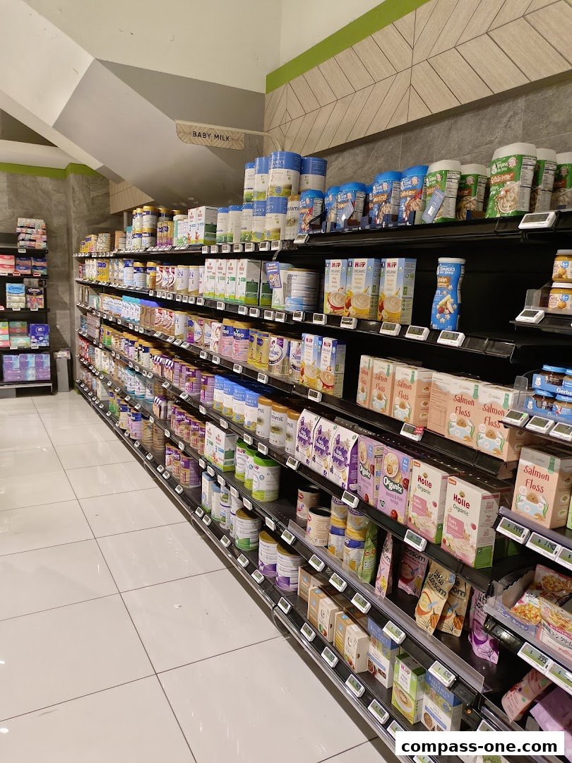 A well-stocked aisle of baby milk and formula products in a supermarket.