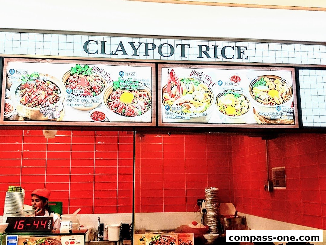 A menu board displaying various claypot rice dishes with prices and images.