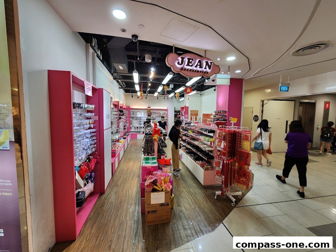 Interior view of a brightly lit shop selling various accessories, with customers browsing.