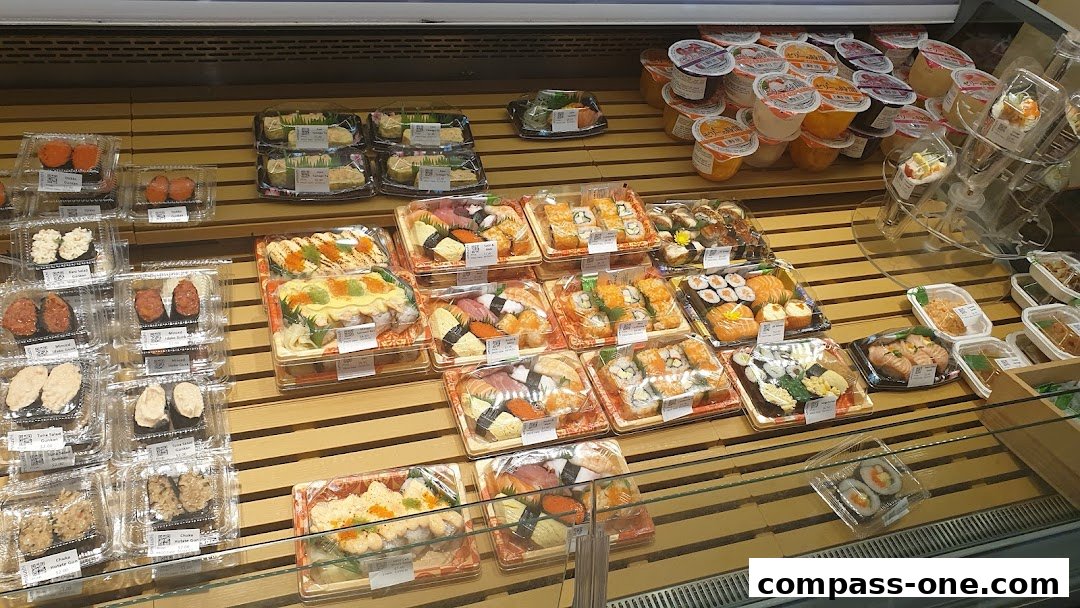 A display of various pre-packaged sushi and dessert cups.