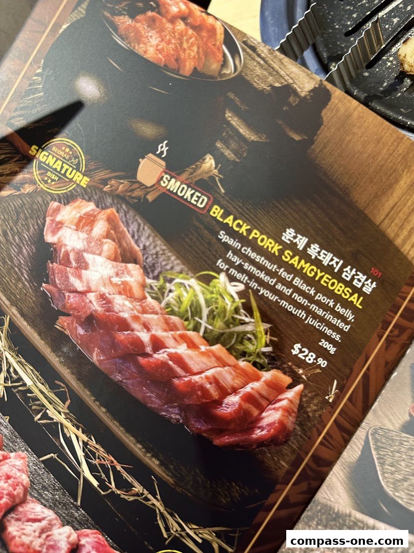 A menu item featuring smoked black pork samgyeopsal with a description and price.