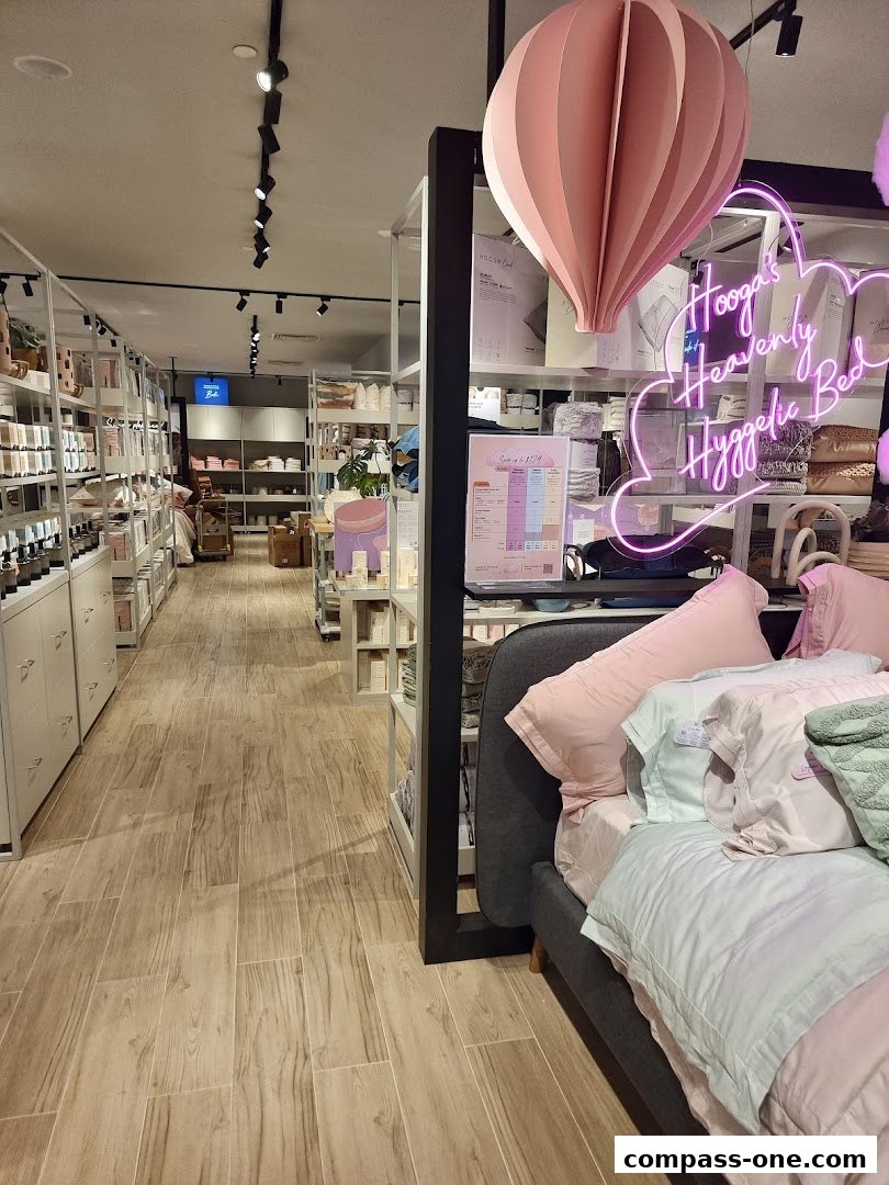 Interior view of a HOOGA store showcasing bedding and home decor items.