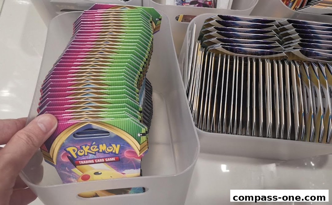 A hand holds a display of Pokemon trading card game booster packs in a store.
