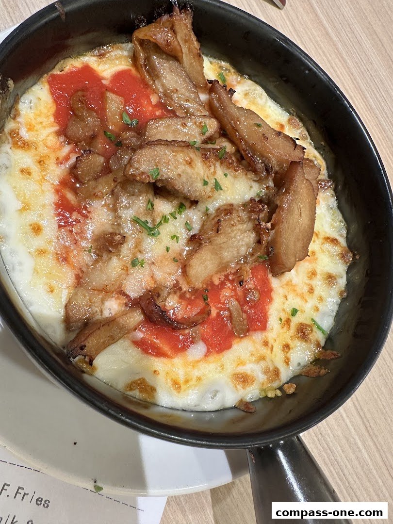 A close-up shot of a delicious baked dish with melted cheese, tomato sauce, and meat.