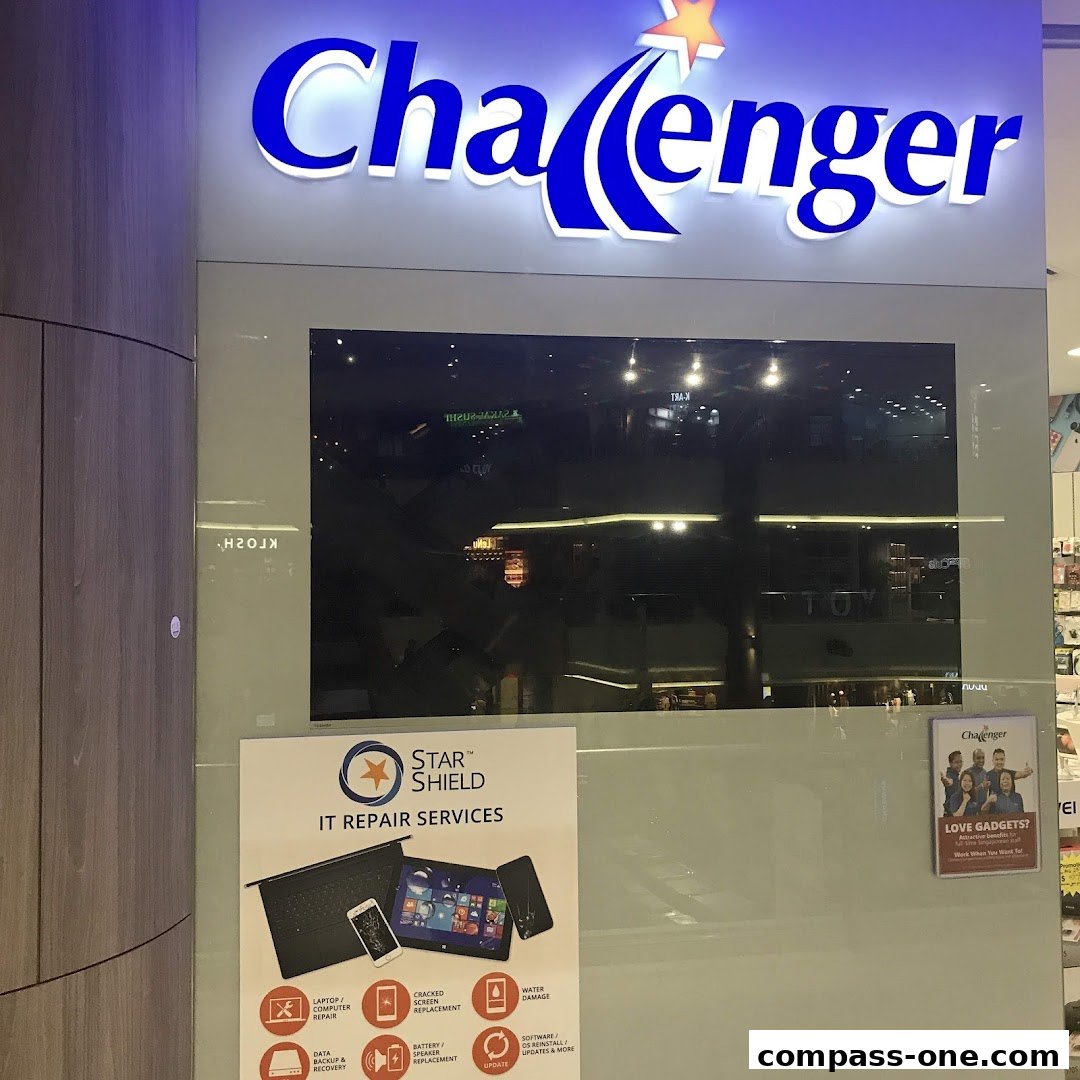 The Challenger store front with its prominent logo and an advertisement for IT repair services.