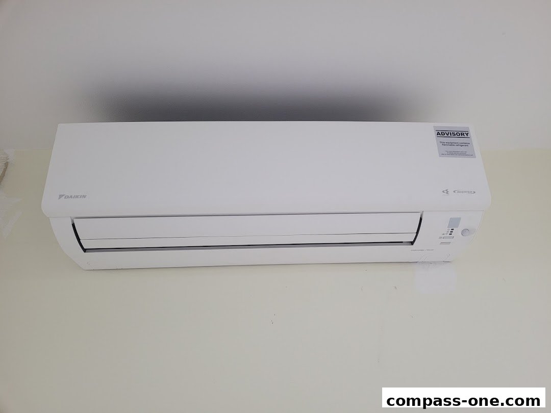 A white Daikin air conditioner unit mounted on a light-colored wall.