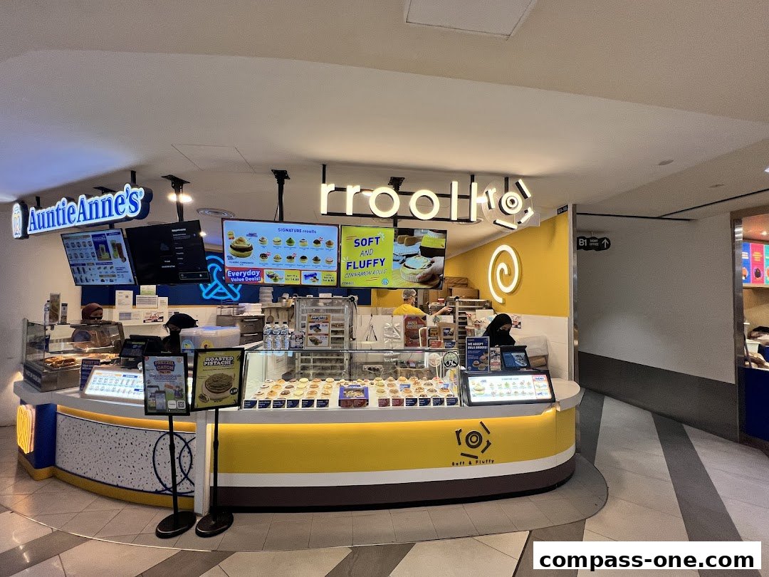 A bright and inviting bakery counter displaying a variety of cinnamon rolls and other baked goods.