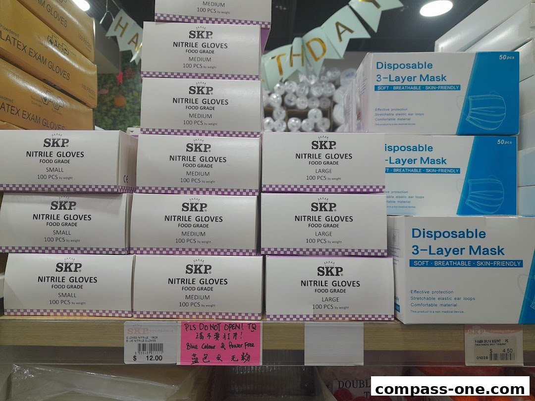 A retail display featuring boxes of SKP nitrile gloves and disposable 3-layer masks.