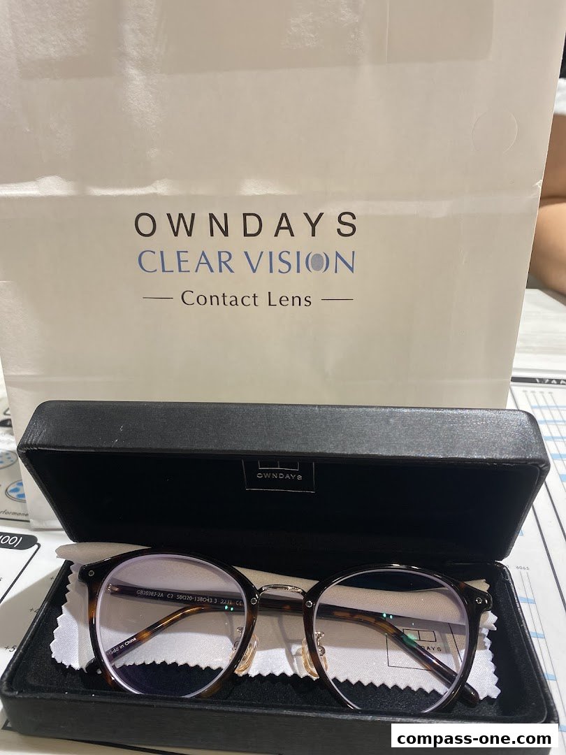 A pair of tortoiseshell glasses in a black case with an OWNDAYS bag in the background.