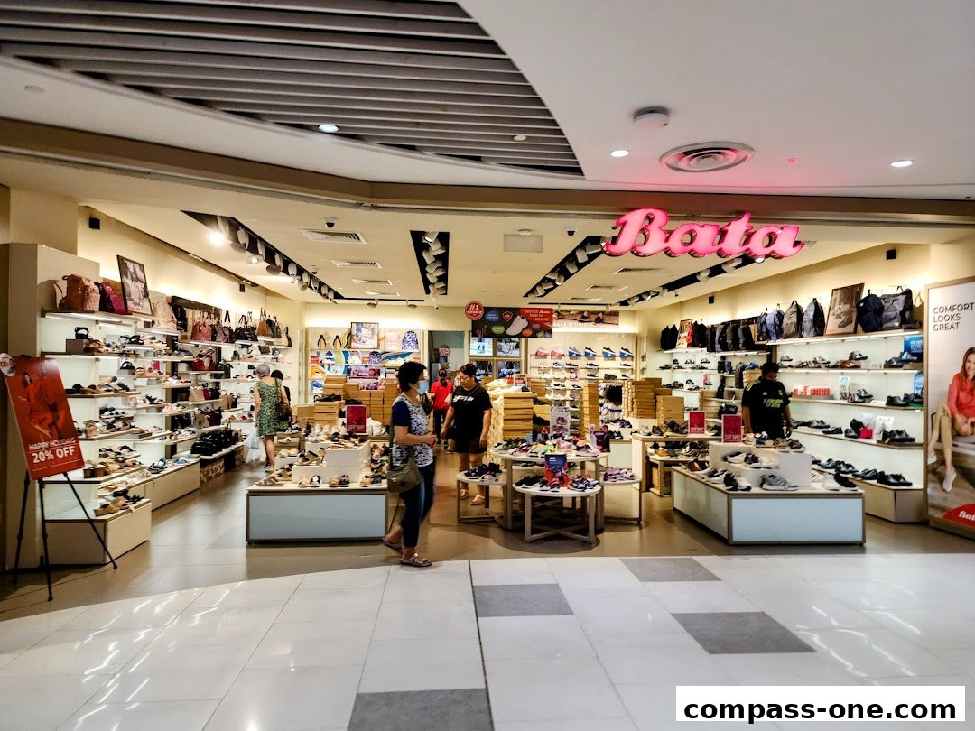 Interior view of a Bata shoe store showcasing a wide variety of footwear and bags.