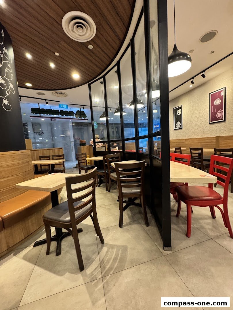 Interior view of a MOS Burger restaurant with tables, chairs, and decor.