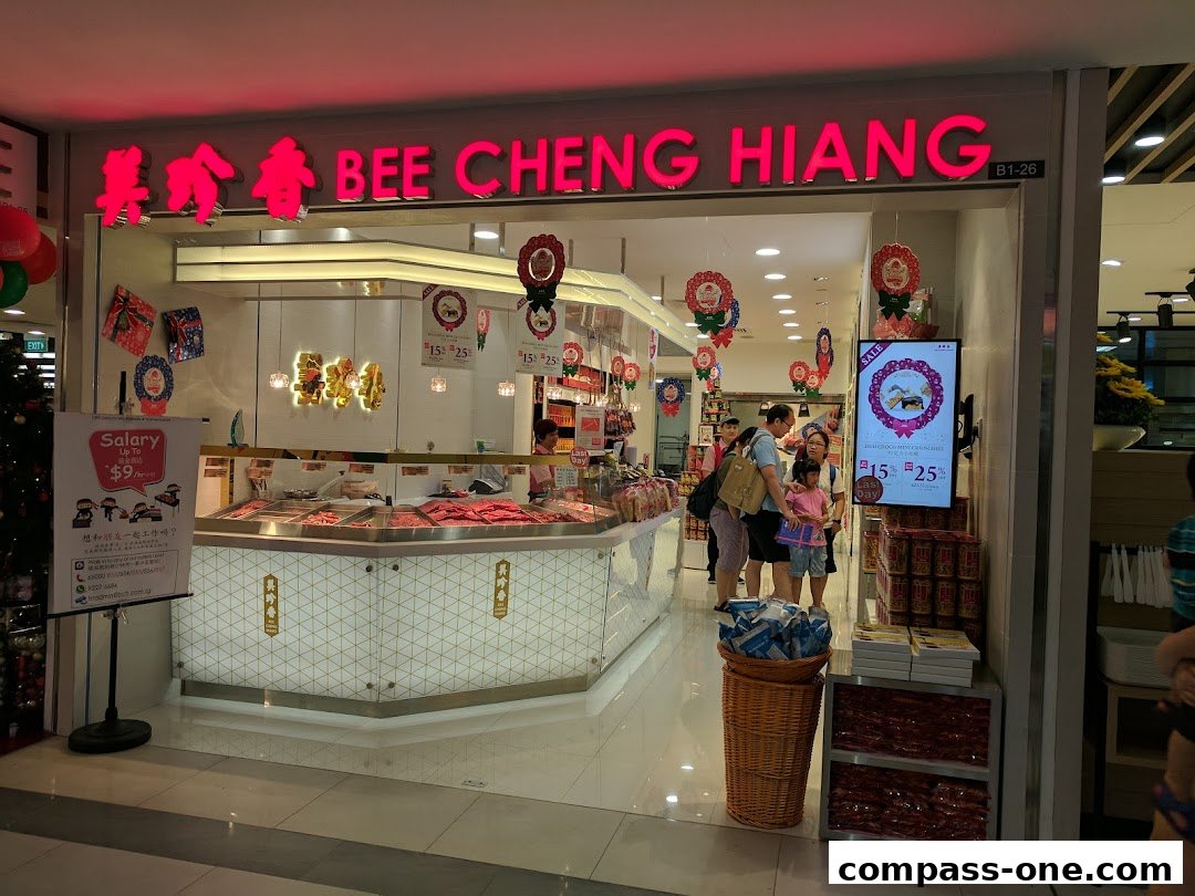 The exterior of a Bee Cheng Hiang shop with a display of meat products and promotional signage.