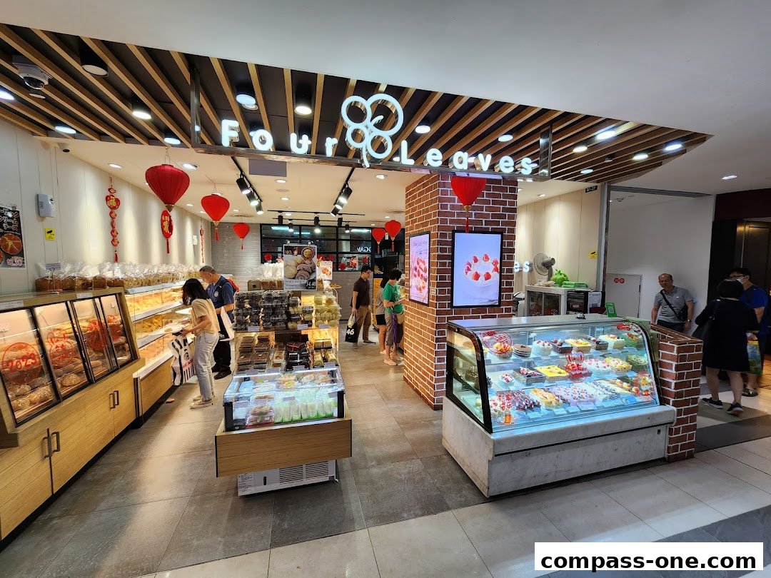 Interior view of a bakery with display cases filled with cakes and pastries.
