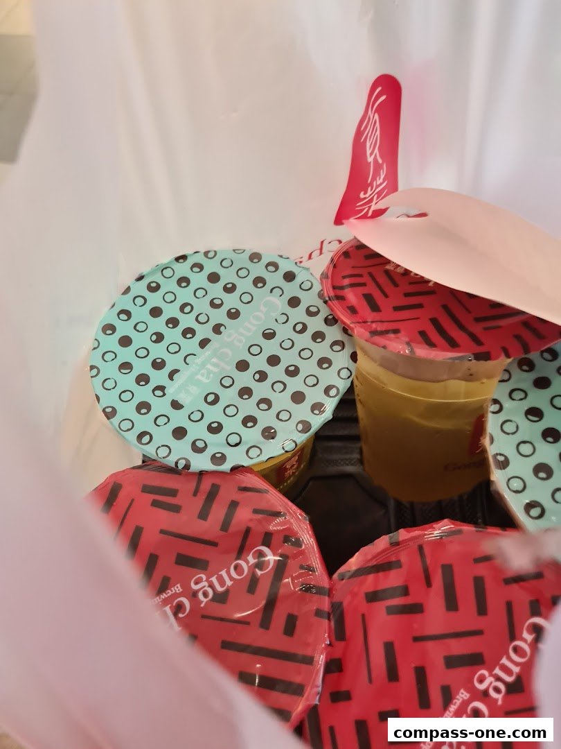 A collection of Gong Cha bubble tea drinks in a bag, with various lid designs.