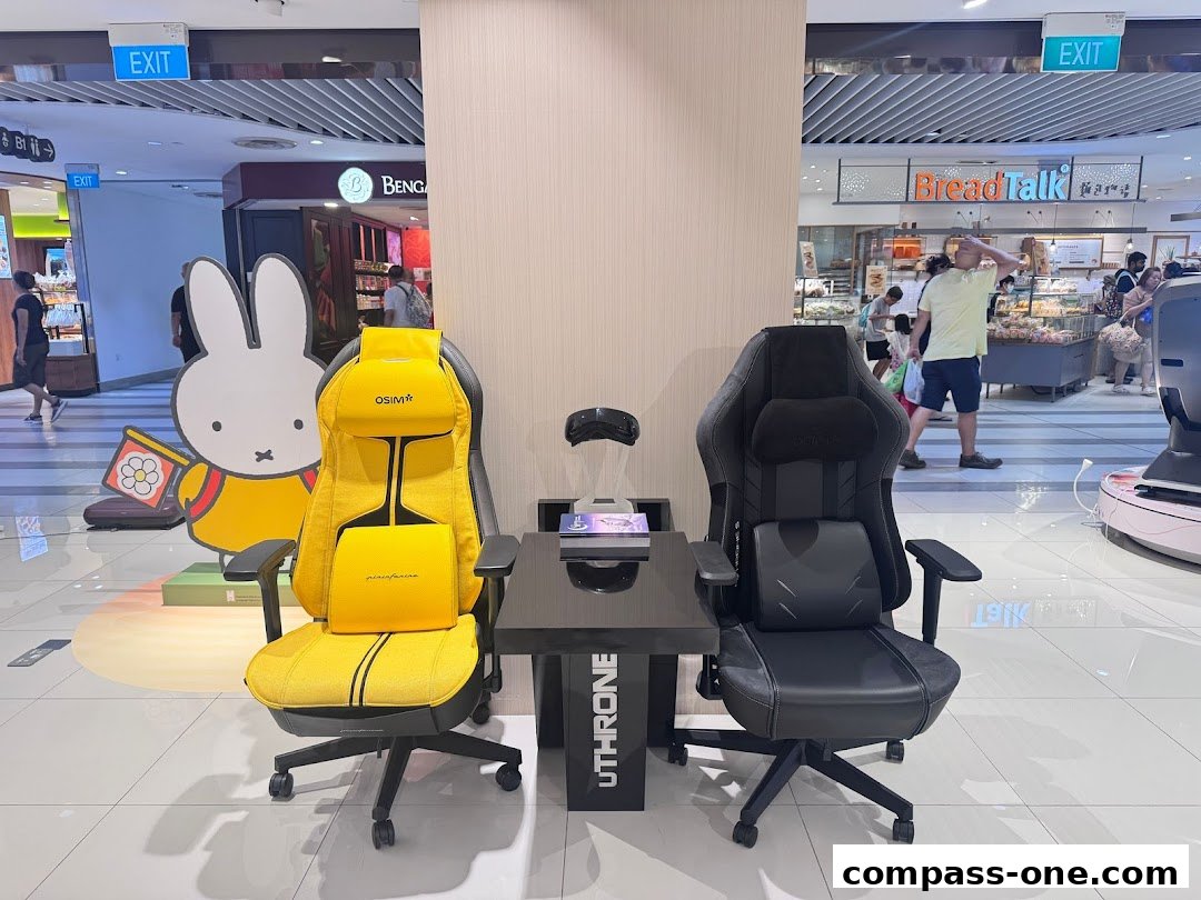 Two ergonomic chairs, one yellow and one black, are displayed with a Miffy cutout and a table.
