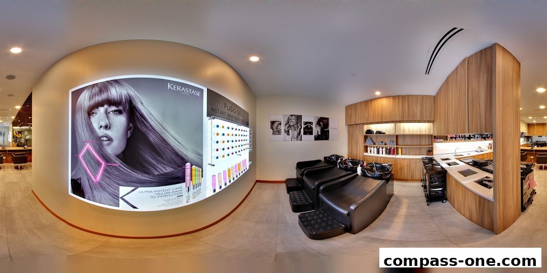 Interior of a modern hair salon with styling stations, hair washing chairs, and product displays.