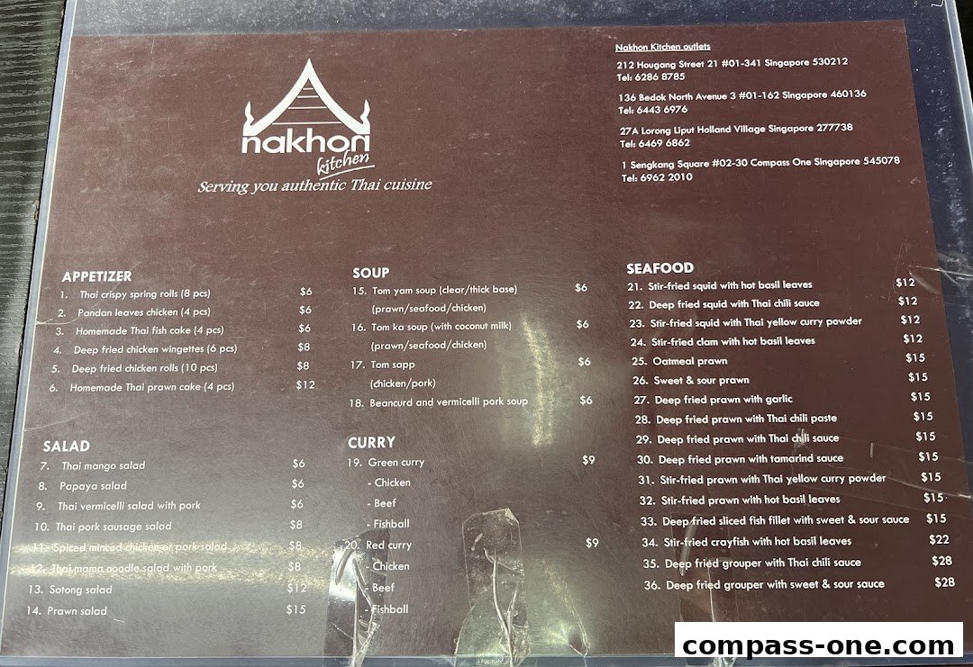 A menu from Nakhon Kitchen, featuring appetizers, salads, soups, curries, and seafood dishes.
