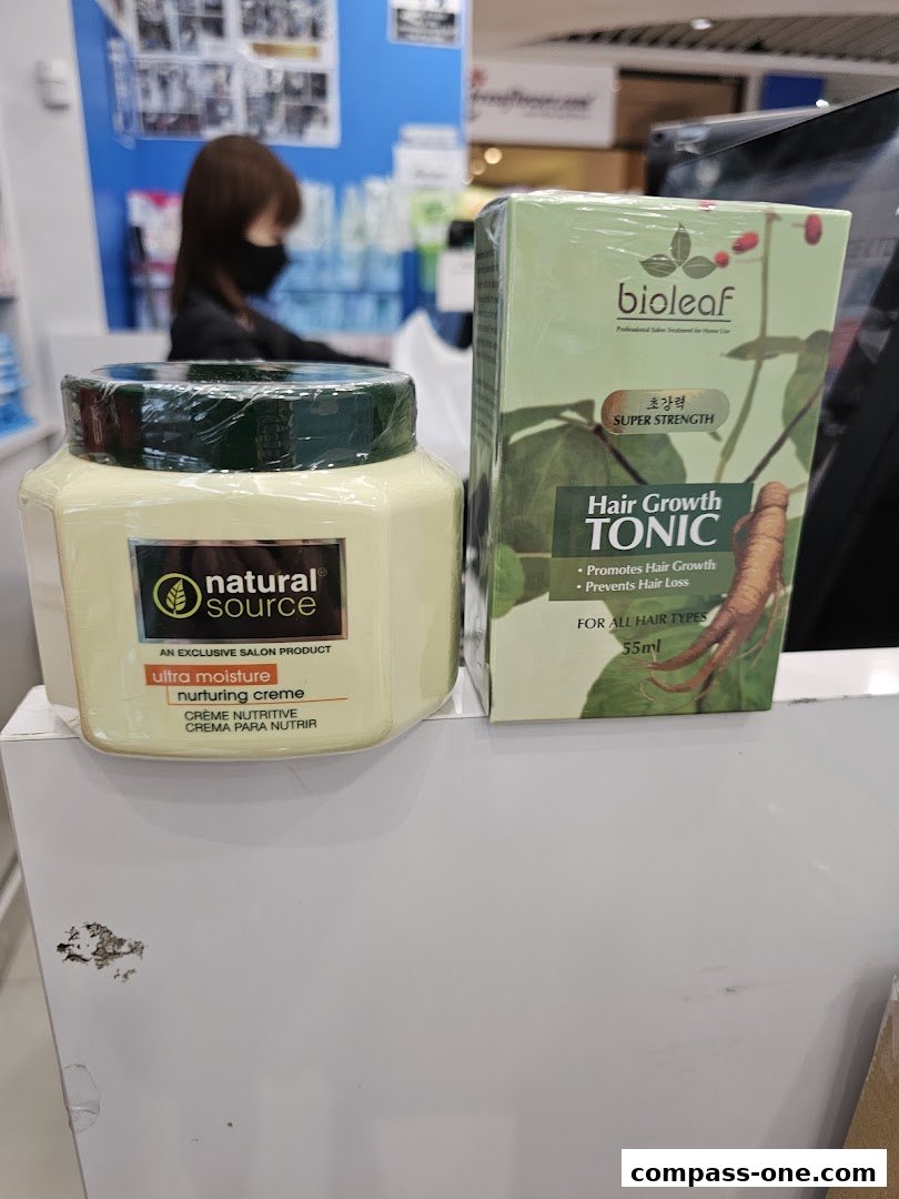 Two beauty products, a nurturing creme and hair growth tonic, are displayed on a counter.