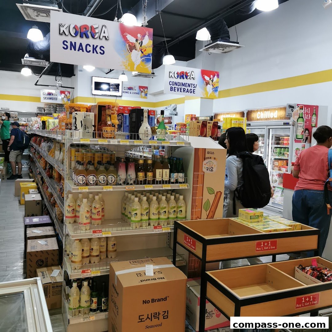 Interior view of a Korean mart showcasing snacks, beverages, and condiments.