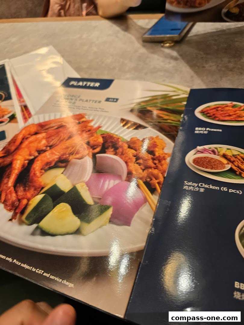 A menu featuring platters with grilled prawns, chicken, and vegetables.