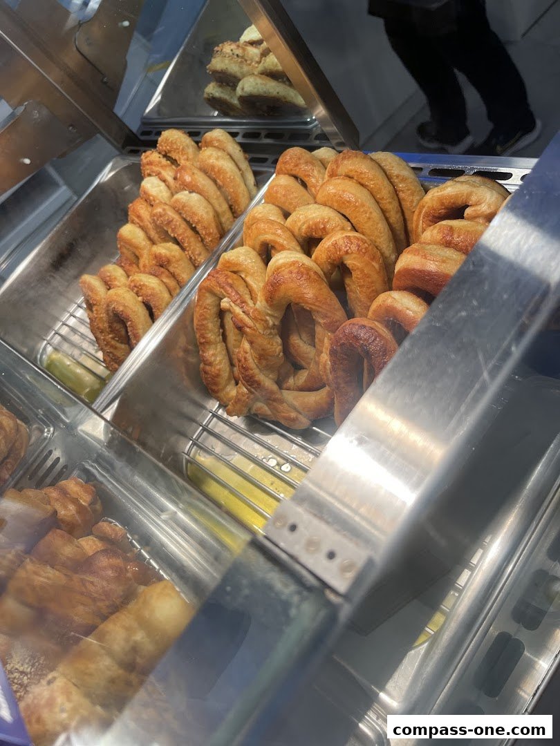 A display case filled with freshly baked pretzels and other pastries.