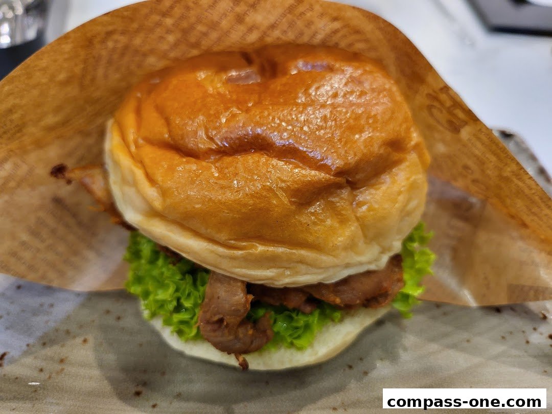 A close-up shot of a delicious burger with fresh lettuce and meat, wrapped in paper.