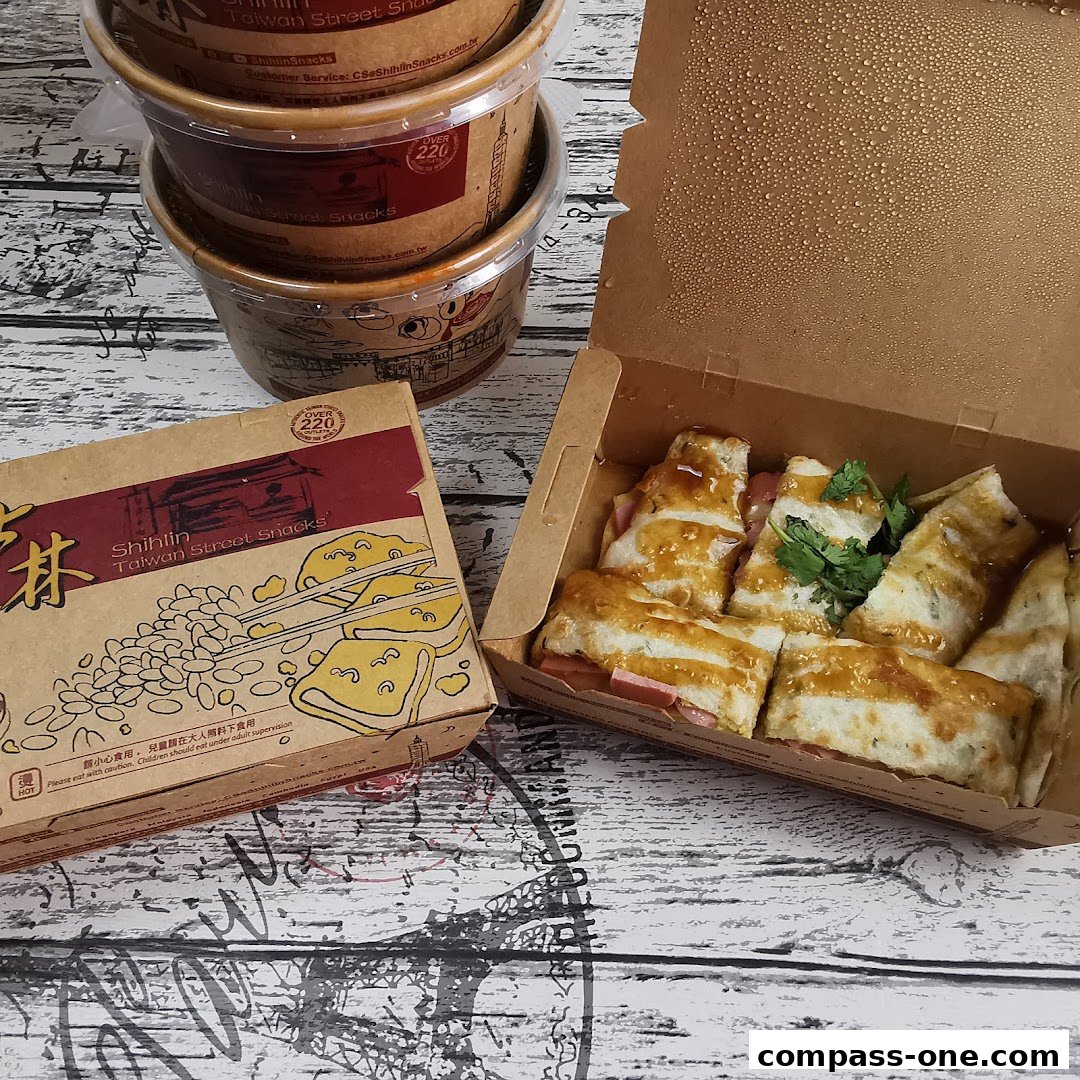 A box of Shihlin Taiwan Street Snacks and several takeout containers.