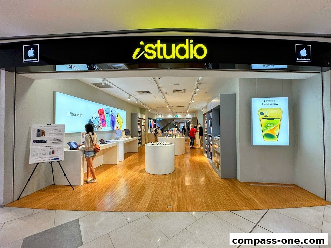The entrance of an iStudio store, showcasing Apple products and promotions.