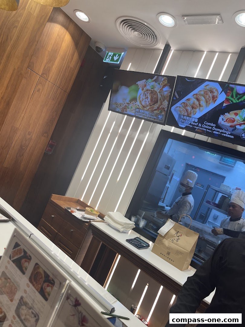 Interior view of Nine Fresh Desserts Taiwan with digital menus and chefs in the background.