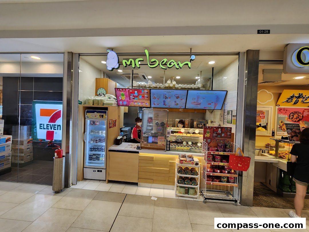 The Mr Bean shop front displays a variety of desserts and drinks with staff serving customers.