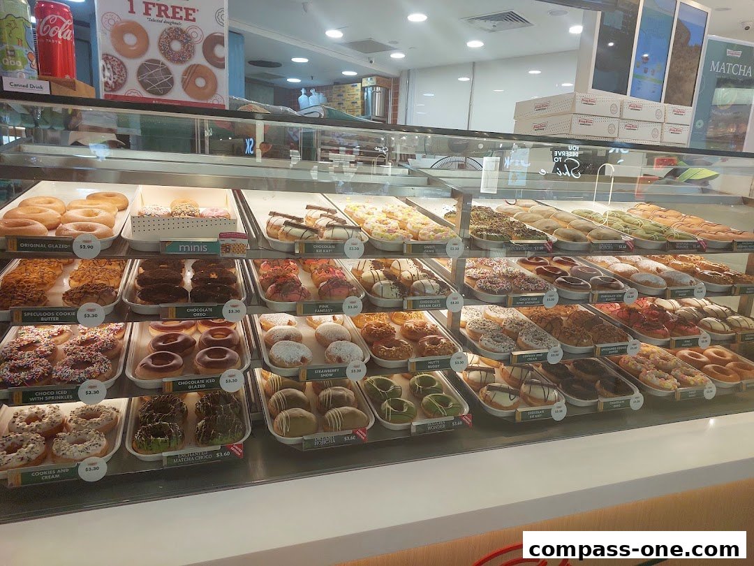 A display case filled with a variety of colorful and delicious donuts at Krispy Kreme.
