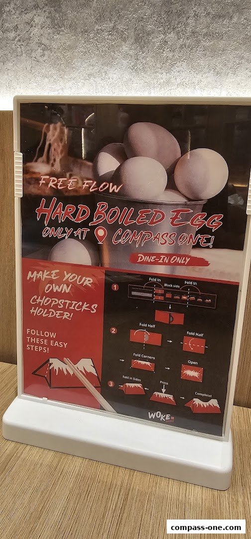 A sign advertising free-flow hard-boiled eggs and instructions for making a chopsticks holder.