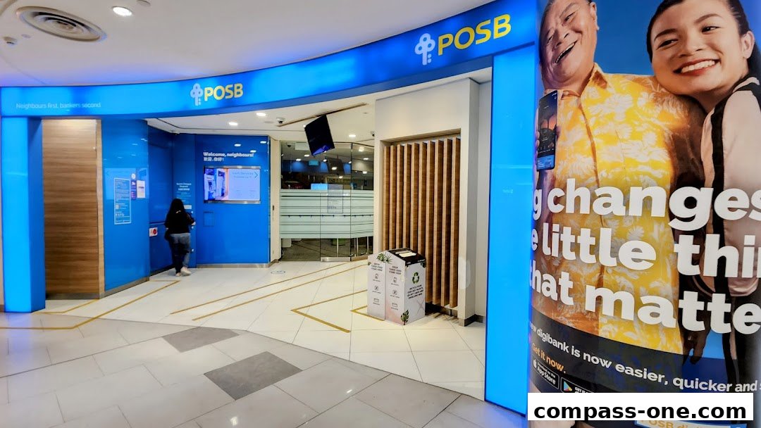 The entrance to a POSB bank branch with a large advertisement featuring smiling people.