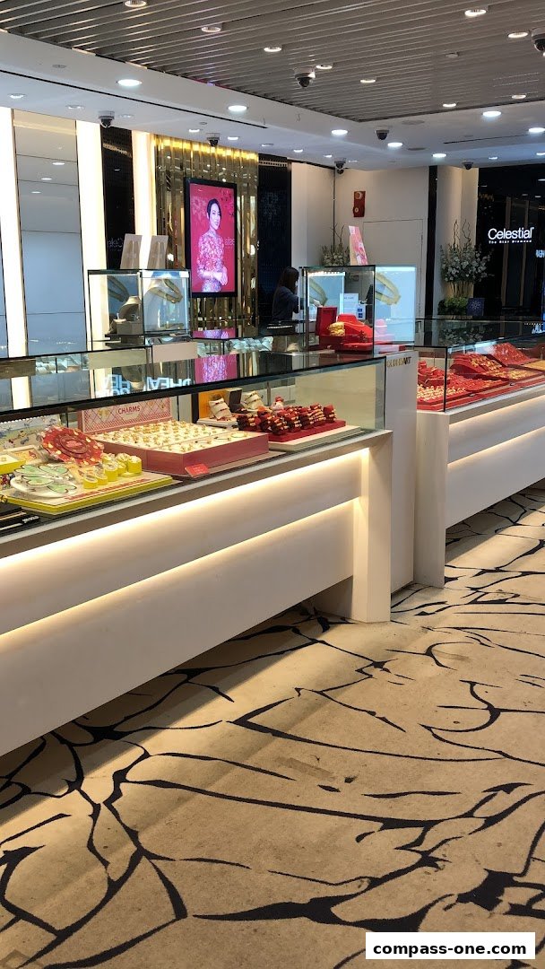 Interior view of a jewelry store with display cases filled with gold jewelry.