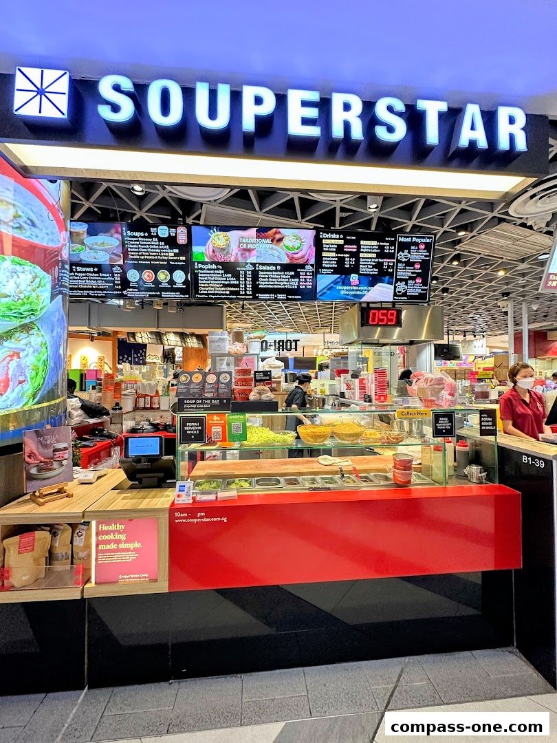The Souperstar shop front with a bright red counter and digital menus displaying food options.