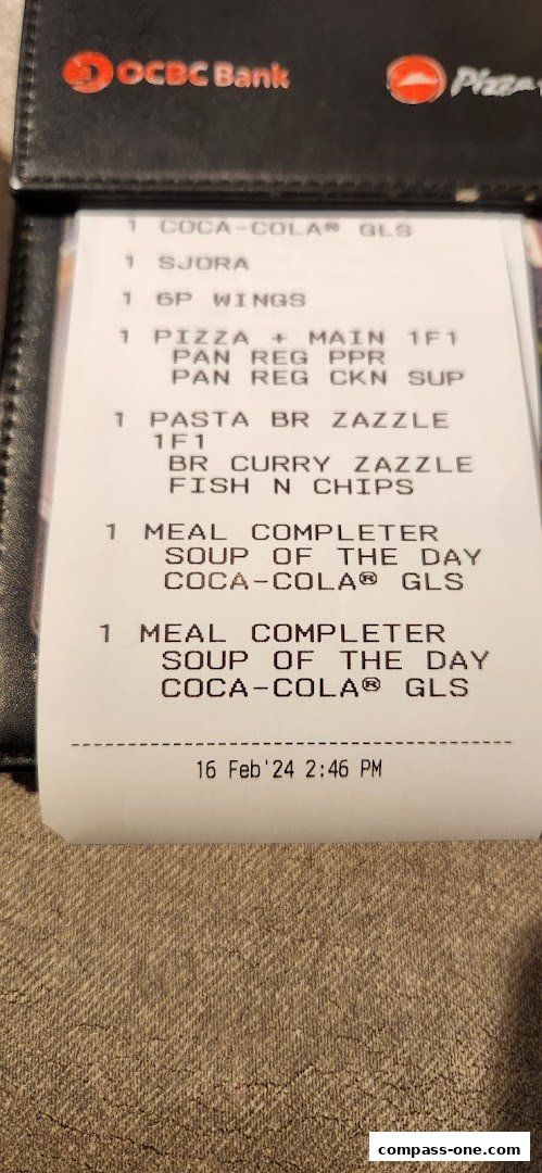 A receipt from Pizza Hut showing various food and drink items ordered.