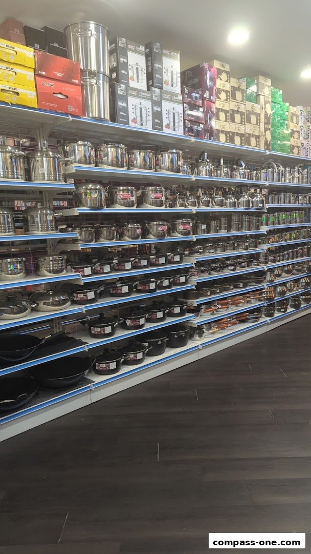 Shelves stocked with various stainless steel cookware, pots, and steamers.