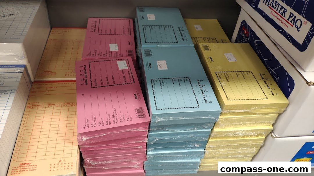 Stacks of colorful work record cards and attendance sheets are neatly organized.