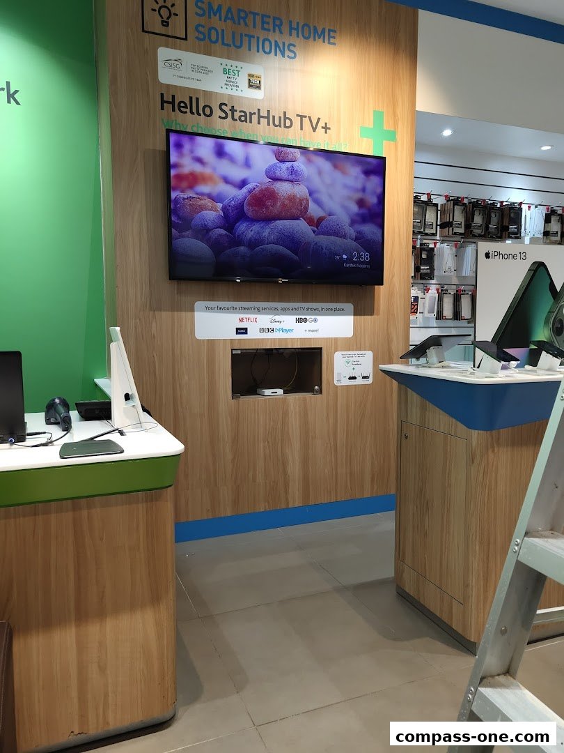 A StarHub store display featuring a large TV screen showcasing streaming services and iPhone accessories.