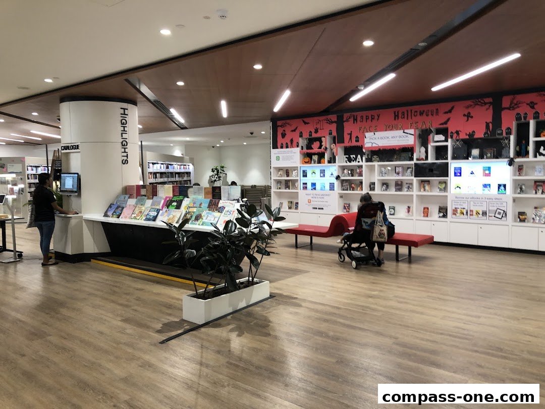 Interior of a library with book displays, seating, and Halloween decorations.